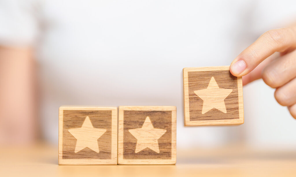 hand holding Star block. Customer choose rating for user reviews. Quality, Service rating, ranking, customer review, satisfaction, evaluation and feedback concept